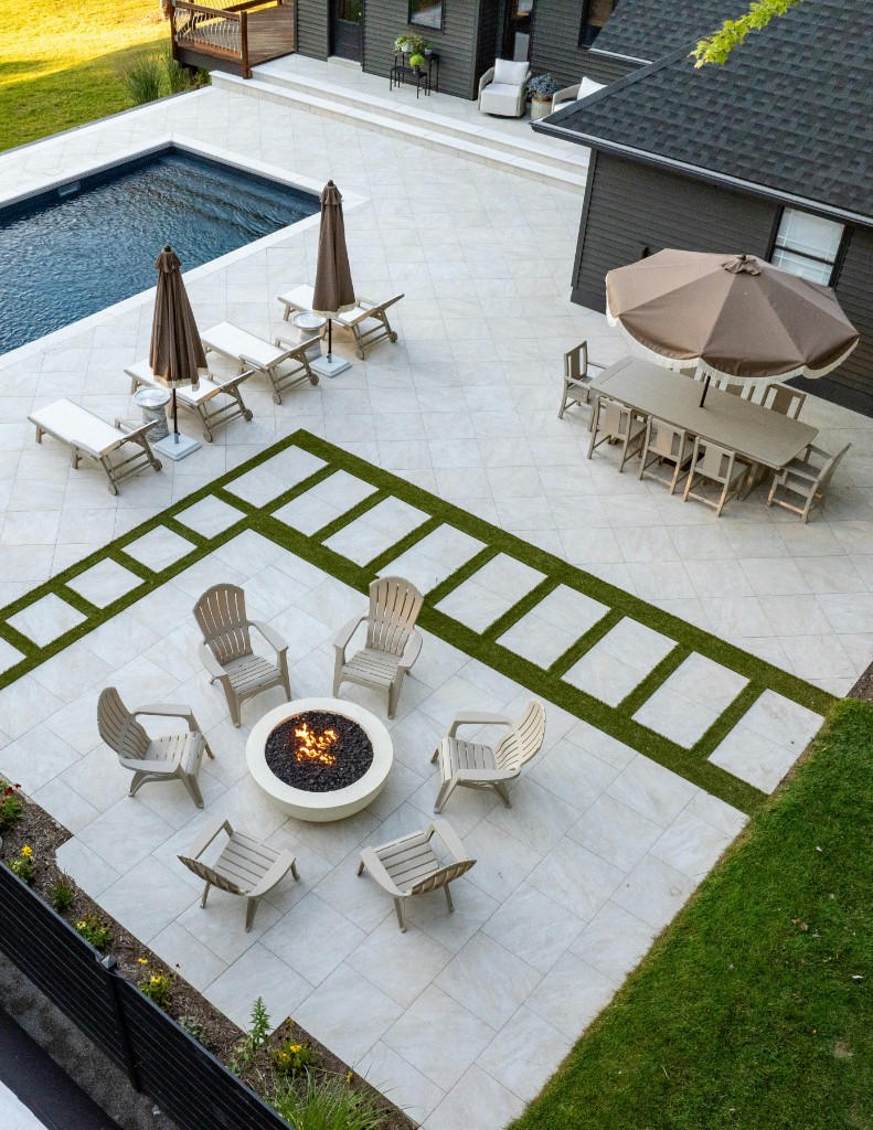 Modern patio with fire pit, pool, and lounge seating