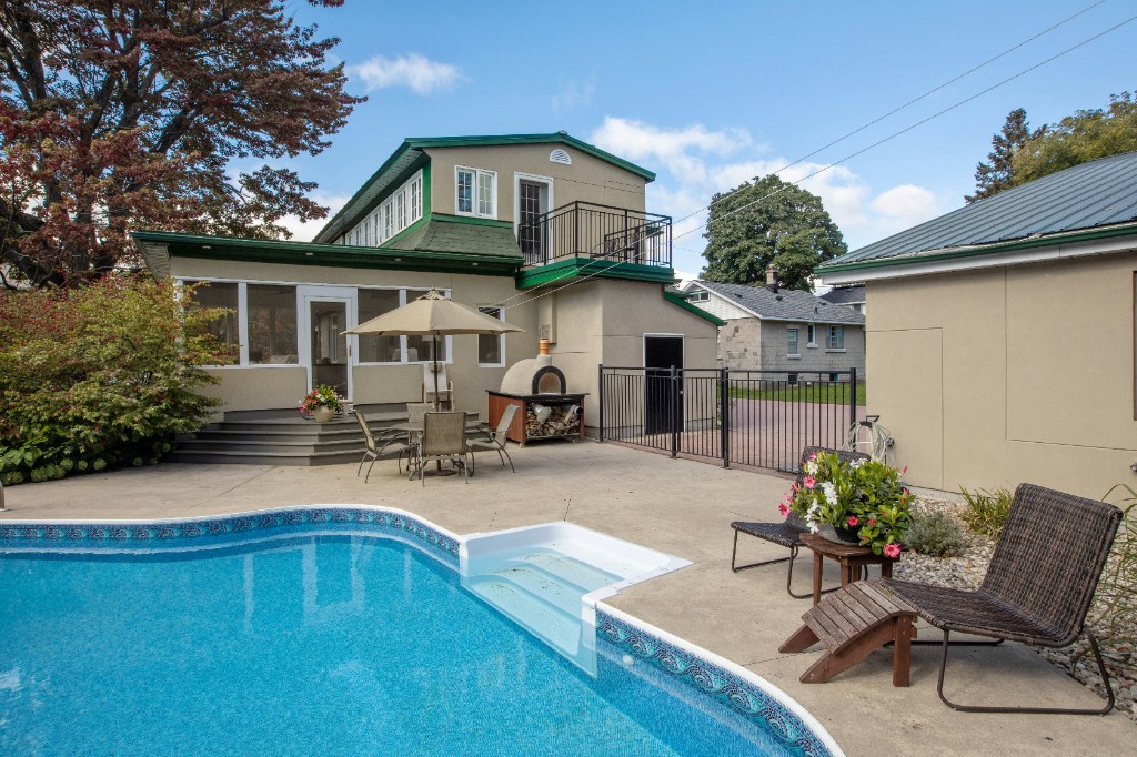 Pool patio with outdoor pizza oven and dining area
